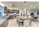 Modern kitchen boasts granite countertops, stainless steel appliances, eat-in island, and adjacent dining area at 8092 Haywood Estate Ave, Las Vegas, NV 89113