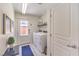 Clean laundry room featuring a modern washer and dryer, with a utility sink and storage at 8092 Haywood Estate Ave, Las Vegas, NV 89113