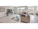 Bright living room with tile flooring, comfortable sofa, and multiple large windows at 8092 Haywood Estate Ave, Las Vegas, NV 89113