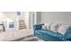 Sitting area on second level features carpet, a blue sofa, and stairway at 8092 Haywood Estate Ave, Las Vegas, NV 89113