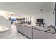 Open-concept living room features tile floors, recessed lighting, and adjoins modern kitchen and dining area at 8092 Haywood Estate Ave, Las Vegas, NV 89113