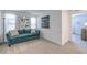 Cozy living room featuring plush sofa, soft carpet, and natural light from the windows at 8092 Haywood Estate Ave, Las Vegas, NV 89113
