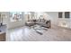 Spacious living room with modern tile flooring, comfortable sofa, and ample natural light at 8092 Haywood Estate Ave, Las Vegas, NV 89113