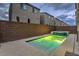 This backyard boasts a sparkling pool with an attached spa and a brick privacy wall, ideal for outdoor relaxation at 8092 Haywood Estate Ave, Las Vegas, NV 89113