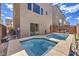 Backyard view featuring a modern pool and spa, a barbecue, comfortable outdoor seating, and privacy wall at 8092 Haywood Estate Ave, Las Vegas, NV 89113