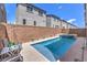 Modern pool with a spa and privacy wall, complemented by comfortable patio seating, and lush greenery at 8092 Haywood Estate Ave, Las Vegas, NV 89113