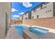 Backyard view featuring a modern pool and spa with an attractive brick privacy wall and comfortable patio seating at 8092 Haywood Estate Ave, Las Vegas, NV 89113