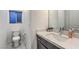 Stylish powder room with marble countertop, modern faucet, toilet, and window at 8092 Haywood Estate Ave, Las Vegas, NV 89113