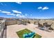 Roof deck featuring an outdoor kitchen, dining area, comfortable seating, and a play area with artificial grass at 8092 Haywood Estate Ave, Las Vegas, NV 89113
