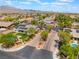 Aerial view featuring community entrance and homes with mature trees at 8125 Soledad Canyon St, Las Vegas, NV 89131