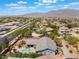 Beautiful aerial view of backyard with inground pool, covered patio, desert landscaping and mountain views at 8125 Soledad Canyon St, Las Vegas, NV 89131