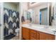 Bathroom showcasing double sinks, vanity with cabinet storage, framed mirrors, and a shower with curtain at 8125 Soledad Canyon St, Las Vegas, NV 89131