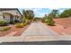 Spacious driveway leading to a charming home with mature landscaping and well-maintained curb appeal at 8125 Soledad Canyon St, Las Vegas, NV 89131