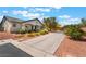 Long driveway leads to a charming single-story house with well-maintained desert landscaping at 8125 Soledad Canyon St, Las Vegas, NV 89131
