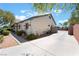 Side view of single-story home with extended driveway and desert landscaping at 8125 Soledad Canyon St, Las Vegas, NV 89131