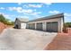Large three-car garage with ample parking space and desert landscaping at 8125 Soledad Canyon St, Las Vegas, NV 89131