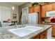 Kitchen island with sink, granite countertop and stainless steel appliances at 8125 Soledad Canyon St, Las Vegas, NV 89131