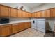 Laundry room featuring cabinets for storage, a long countertop, and a washer and dryer set at 8125 Soledad Canyon St, Las Vegas, NV 89131