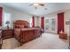 This main bedroom features a ceiling fan, shuttered windows and french doors with access to a seating area at 8125 Soledad Canyon St, Las Vegas, NV 89131