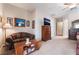 The expansive main bedroom has an attached sitting area, ceiling fan and a neutral carpet at 8125 Soledad Canyon St, Las Vegas, NV 89131