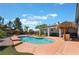 Backyard pool with tropical accents, tanning deck and covered patio at 8125 Soledad Canyon St, Las Vegas, NV 89131