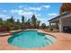 Backyard pool with tropical accents, waterfall feature and mature landscaping at 8125 Soledad Canyon St, Las Vegas, NV 89131