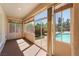 Bright sunroom with sliding doors and windows offering backyard pool views at 8125 Soledad Canyon St, Las Vegas, NV 89131