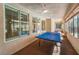 Bright sunroom with a ping pong table, ceiling fan and lots of natural light at 8125 Soledad Canyon St, Las Vegas, NV 89131