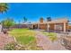 A well-maintained backyard featuring a covered patio, a green lawn, and vibrant landscaping, creating a perfect outdoor oasis at 819 Arrowhead Trl, Henderson, NV 89002