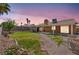 A sprawling backyard boasts a covered patio, well-kept lawn, and landscaped areas, creating a serene outdoor space at 819 Arrowhead Trl, Henderson, NV 89002