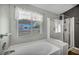 Bright bathroom featuring a large window, glass shower, and soaking tub at 819 Arrowhead Trl, Henderson, NV 89002
