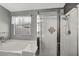 Bright bathroom featuring a soaking tub and glass shower with dual shower heads at 819 Arrowhead Trl, Henderson, NV 89002