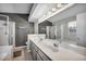 Bright bathroom featuring double sinks, a separate shower, and a large mirror at 819 Arrowhead Trl, Henderson, NV 89002