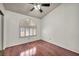 Bedroom featuring hardwood floors, and a striking arched window detail at 819 Arrowhead Trl, Henderson, NV 89002