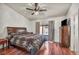 Bedroom featuring a bed, ceiling fan, dresser and backyard views at 819 Arrowhead Trl, Henderson, NV 89002