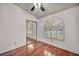 Bedroom featuring a window, mirrored closet doors and hardwood floors at 819 Arrowhead Trl, Henderson, NV 89002
