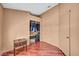 Bedroom with hardwood floors, closet, and a small table on the side at 819 Arrowhead Trl, Henderson, NV 89002