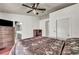 Bedroom featuring a bed, ceiling fan, dresser, hardwood floors and an ensuite at 819 Arrowhead Trl, Henderson, NV 89002