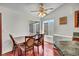 Bright dining area with hardwood floors, a ceiling fan, table, and large windows for natural light at 819 Arrowhead Trl, Henderson, NV 89002