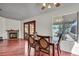 Dining area with backyard access, cozy fireplace, ceiling fan, and seating for four at 819 Arrowhead Trl, Henderson, NV 89002