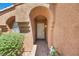 Inviting front entrance featuring a well-lit doorway and desert-style landscaping at 819 Arrowhead Trl, Henderson, NV 89002
