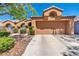 Beautiful single-story home features a two-car garage and desert landscaping with mature shrubs at 819 Arrowhead Trl, Henderson, NV 89002