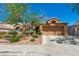 Charming single-story home with a well-maintained desert landscape and a spacious two-car garage at 819 Arrowhead Trl, Henderson, NV 89002