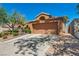 Inviting single-story home featuring a two-car garage and a desert landscape, plus an extended driveway at 819 Arrowhead Trl, Henderson, NV 89002