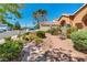 Inviting desert landscaping in front of a single-story home featuring a bench seating area at 819 Arrowhead Trl, Henderson, NV 89002