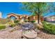 Inviting single-story home with a step stone walkway, desert landscaping, and mature greenery at 819 Arrowhead Trl, Henderson, NV 89002