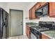 This functional kitchen is equipped with black appliances, wooden cabinets, and ample counter space at 819 Arrowhead Trl, Henderson, NV 89002