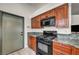 This functional kitchen is equipped with black appliances, wooden cabinets, and ample counter space at 819 Arrowhead Trl, Henderson, NV 89002