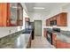 Charming kitchen features wood cabinets, granite countertops, and black appliances at 819 Arrowhead Trl, Henderson, NV 89002