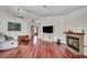 Spacious living room featuring a cozy fireplace, hardwood floors, and ample natural light at 819 Arrowhead Trl, Henderson, NV 89002